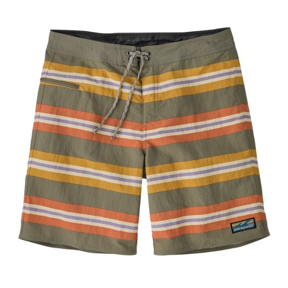 EcoWave Surf Trunks shown on a model at the beach, perfect for surfing and swimming.