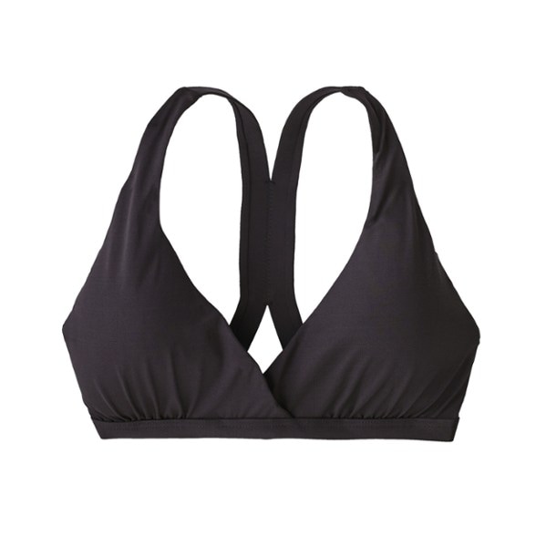 Eco-friendly women's swim top in a sunny beach setting.