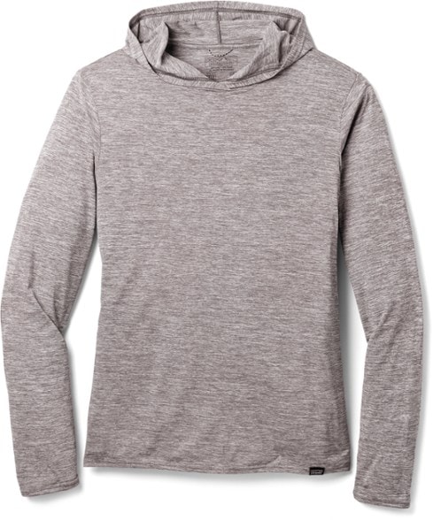 A man in a blue Patagonia Capilene Cool Daily Hoody stands on a mountain trail, looking out at the vista, highlighting its use as an athletic sun hoody.