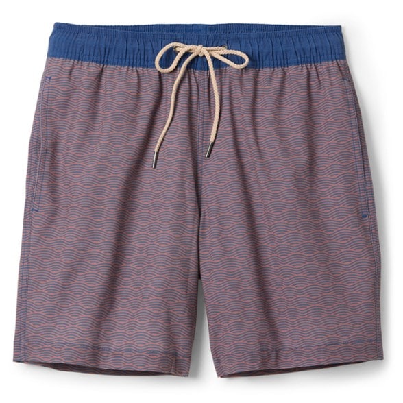 Front view of 7 inch inseam swim trunks styled by beachside, showing tapered fit and elastic waistband.
