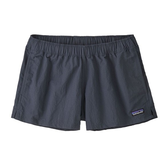 Patagonia Barely Baggies shorts on a model at the beach, showcasing quick-drying fabric.