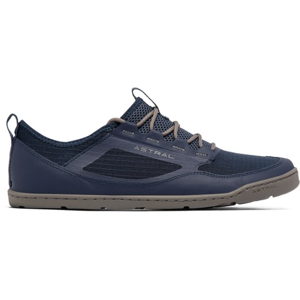 Astral Loyak AC water shoes on a rocky beach, showcasing their quick-drying capability.