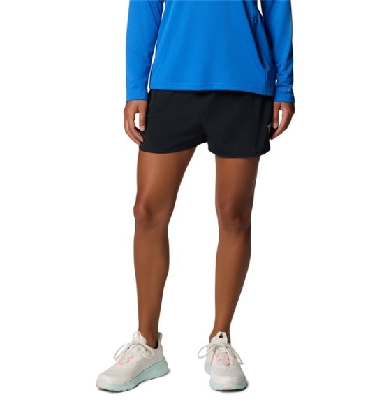 Woman wearing Columbia Windy Bay SwiftDry shorts by a lake, demonstrating their suitability as outdoor shorts.