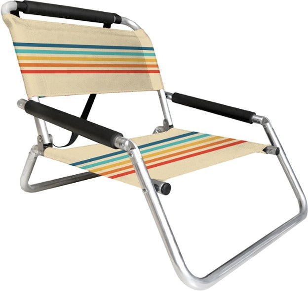 Neso Low-Profile Portable Beach Chair with storage at the beach, showcasing its water-resistant fabric and low design.