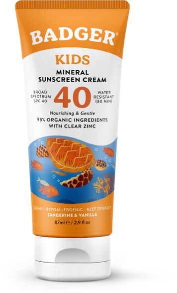SunnyShield SPF 40 kids mineral sunscreen cream in a playful beach setting, showcasing its packaging and texture.