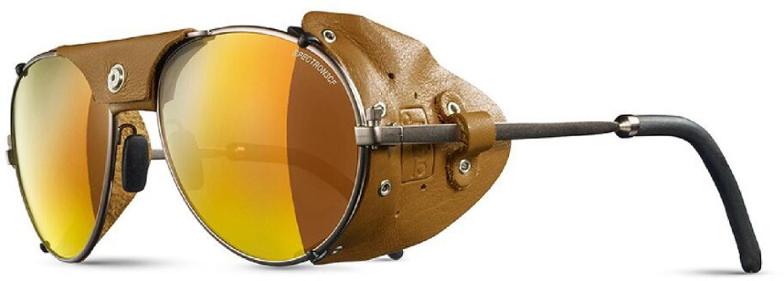 Close-up view of retro mountaineering sunglasses with leather side shields, perfect for snow travel.