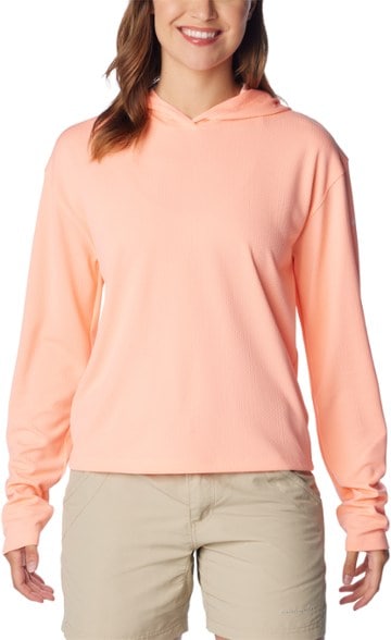 Front view of women's cropped fishing shirt with UPF, shown on model lakeside