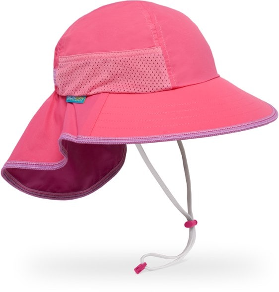 A happy child wearing a blue Adventure Explorer kids sun hat, looking up at the sun on a sunny day.