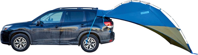 Kelty Sideroads Vehicle Canopy set up at a campsite, showcasing its spacious design and weather protection.