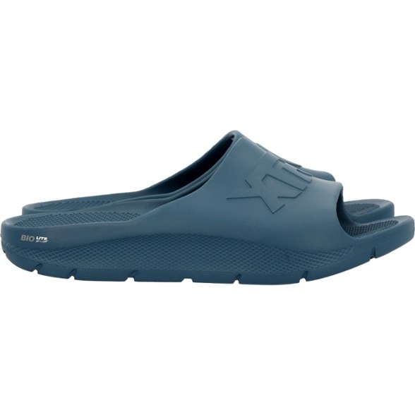 Apres Fish Sandals for men on a wooden dock, showcasing slip-resistant soles