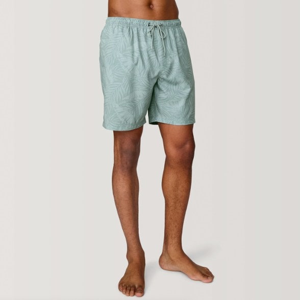 Men wearing Sunset Voyage swim shorts during water activity with UPF protection