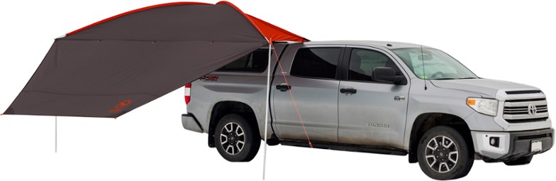 Side angle of ShadeFlex camping tarp mounted on a car, showcasing vehicle shade functionality