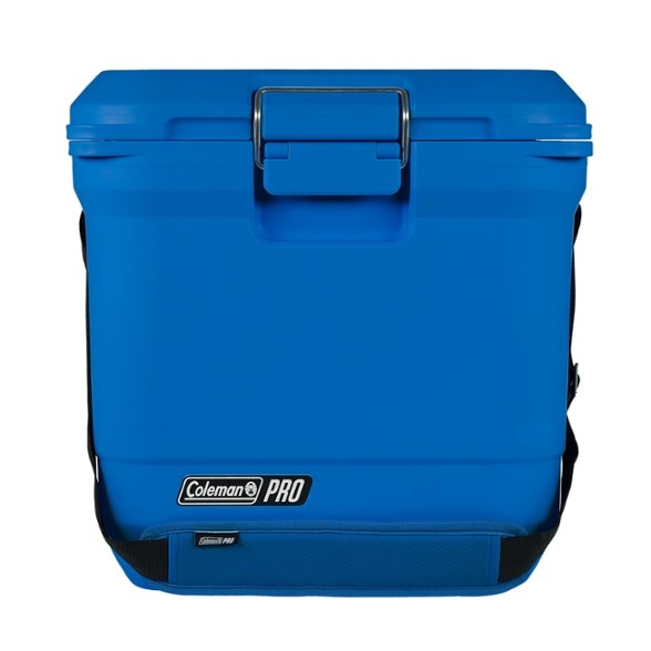 Coleman hard cooler with padded strap in outdoor setting, showing durability