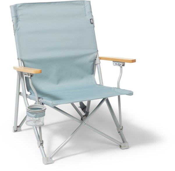 Folding camping chair with cup holder in use at a campsite