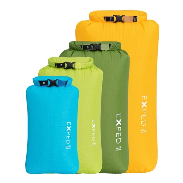 Exped Ultralight Dry Bags Set laid flat on a mossy rock, showing all four sizes