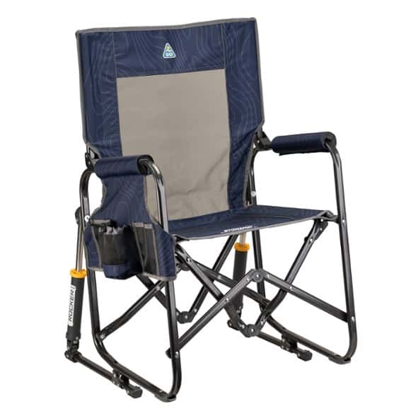 Front angle of the TrailEase foldable outdoor rocking chair with cup holder set up at a campground