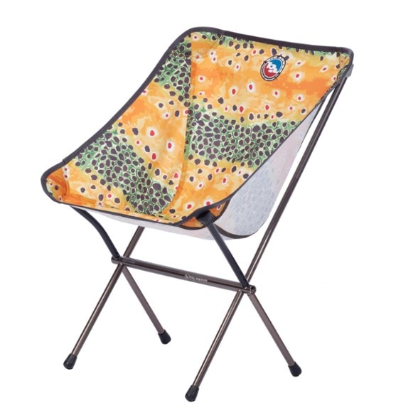 Mica Basin Lightweight Camping Chair in a forest setting, showcasing its compact design.