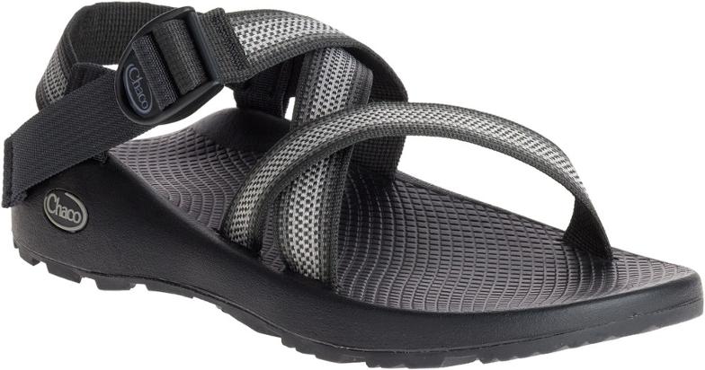 Side view of men's Chaco sandals with adjustable webbing straps on rocky terrain