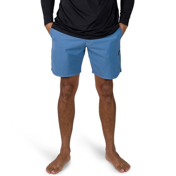 VISSLA men’s board shorts caught in action on a surfboard, showcasing the durable fabric and caliper sides.