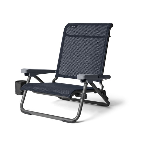 YETI Hondo Portable Lounge Chair set up on the beach with a drink holder.