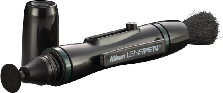 ProOptics LensCare Pen held by a hand, poised to clean a DSLR camera lens, highlighting its compact size and ergonomic design for easy lens cleaning.