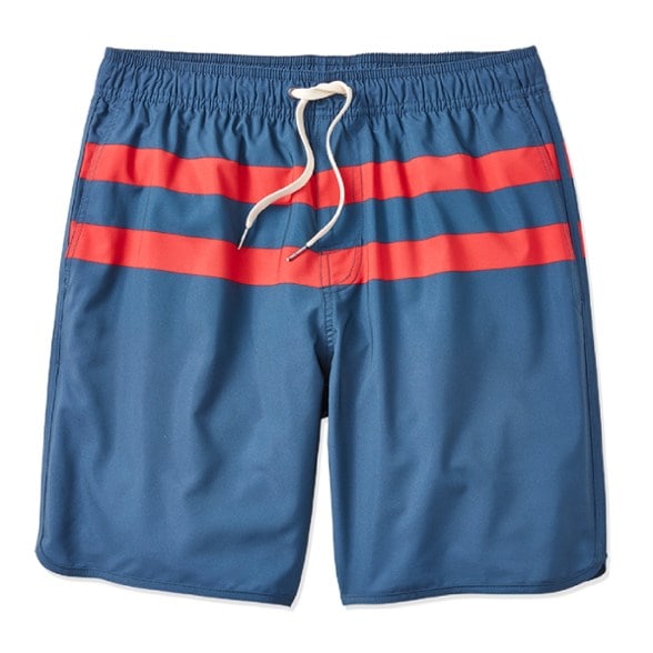 Man wearing Anchor athletic fit swim trunks with an 8-inch inseam, standing by the ocean
