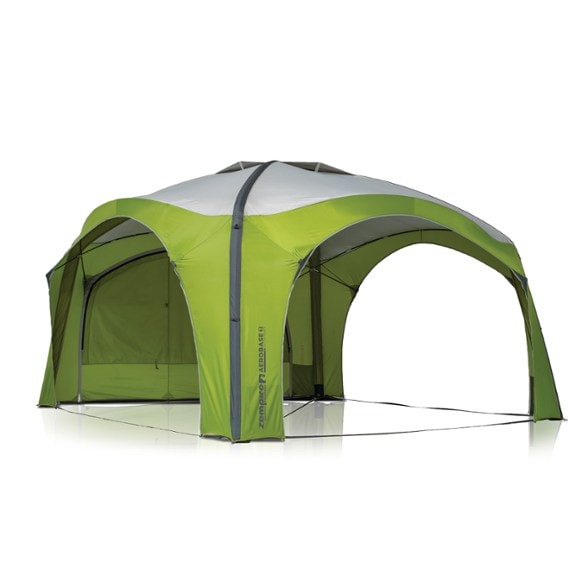 Inflatable camping gazebo set up at a beach with people relaxing under it.