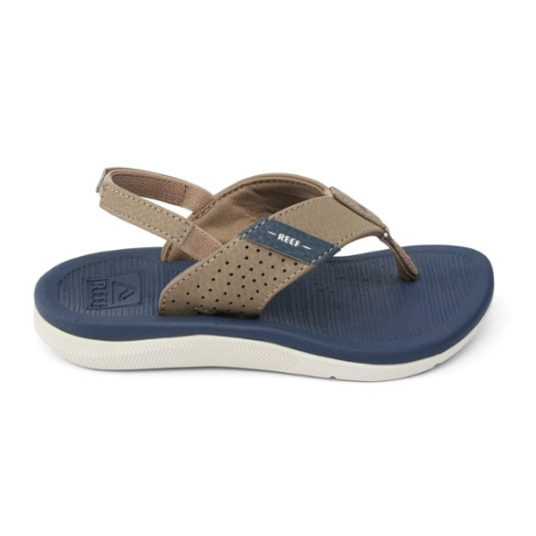 Close-up of Reef SplashGuard toddler flip-flops showing soft footbed texture and synthetic straps