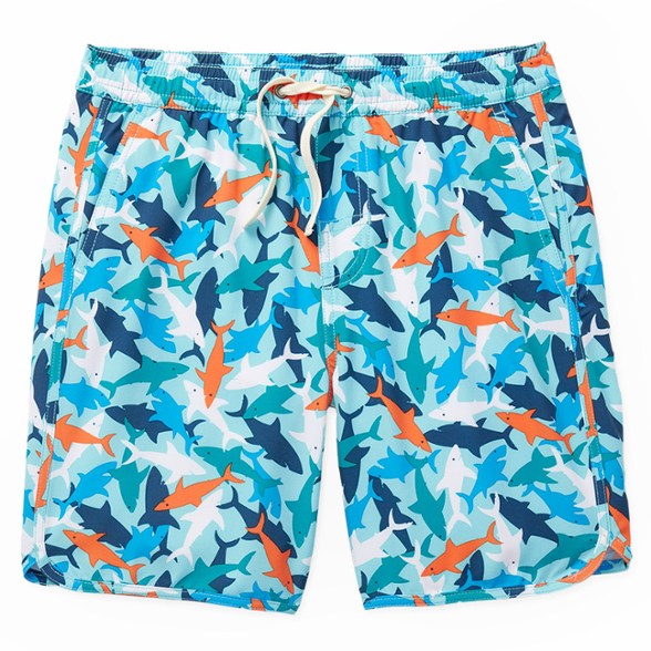 Kids enjoying a sunny day at the beach wearing eco-friendly swim shorts with built-in liner