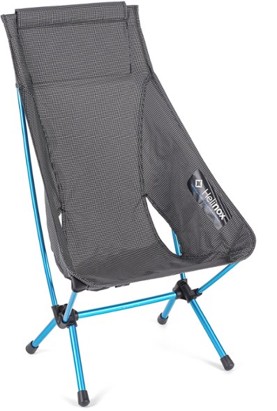 Helinox Highback Lite Camping Chair in a forest setting, showcasing its ergonomic design and high back support.