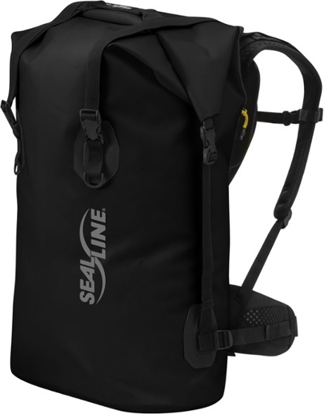 Black Canyon 65L dry pack on a kayak deck, showing lash points and roll-top closure