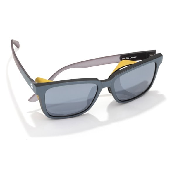 Side profile of Couloir Elite Polarized Sunglasses on a man, highlighting the sleek black frame and magnetic side shield in an outdoor setting.