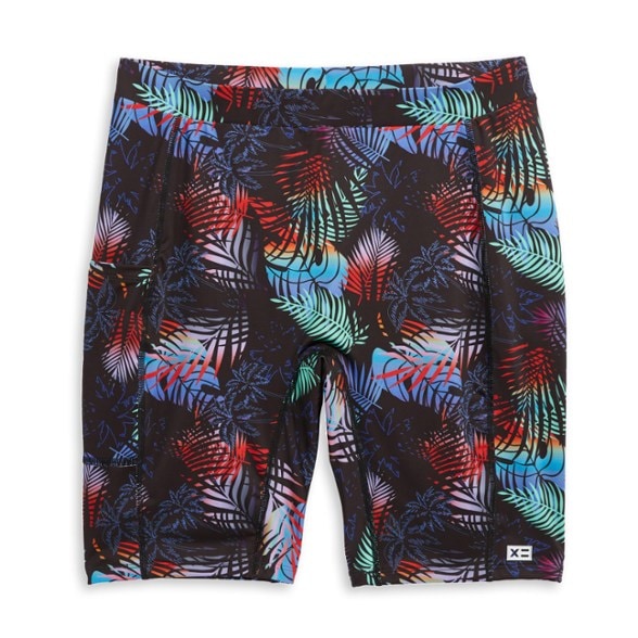 Eco-friendly women's swim shorts in motion at the beach, showcasing excellent fit and style.