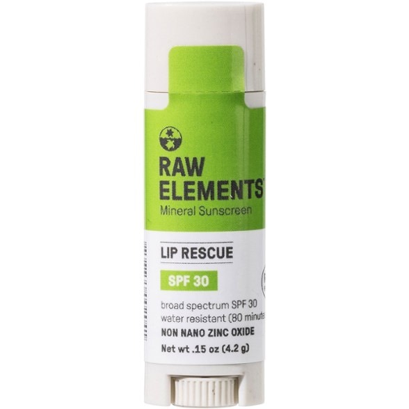 Close-up of Ultimate SPF 30 Lip Rescue against sunlit beach backdrop