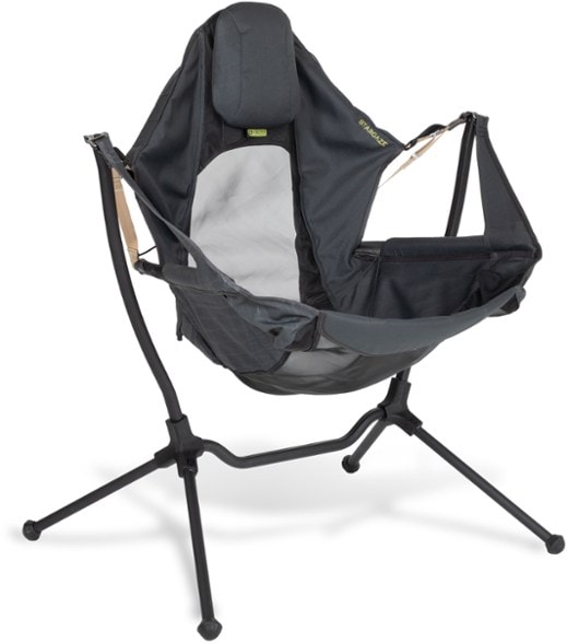 Person comfortably relaxing in a Zenith Recliner, a hammock-style camp chair, with a starry night sky visible in the background, showcasing its ideal use for stargazing.