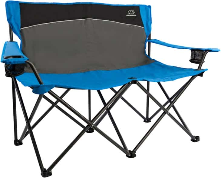 Front angle of folding loveseat with cup holders in use at a campsite
