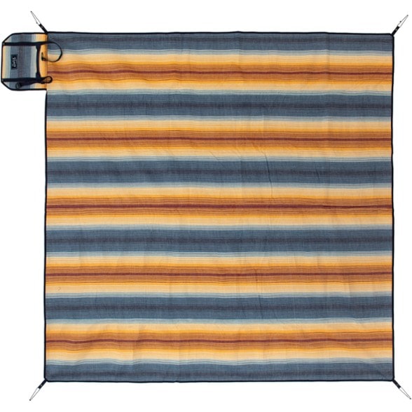 Outdoor blanket laid out at a beach, showing flannel top and waterproof base