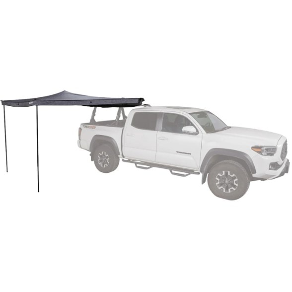 Trailblazer 270° vehicle awning fully extended on a SUV, providing shade over a camping setup with chairs and a table.