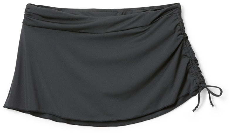 Side view of Radiant Hoku Swim Skirt in motion at the beach, showcasing its stylish design and UPF protection.