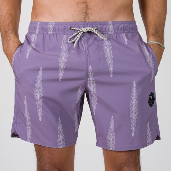 Men modeling board shorts at beach, showing elastic waistband detail