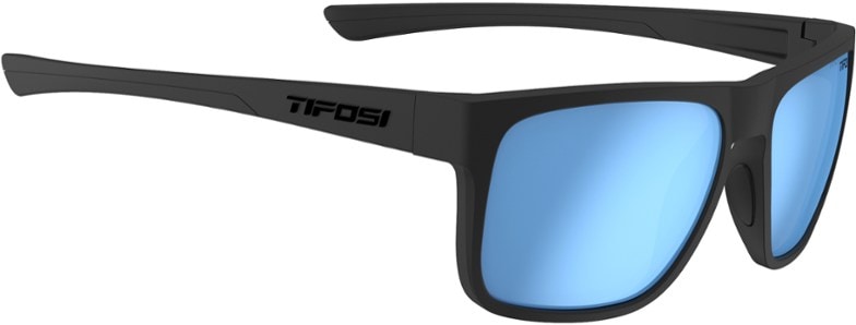 A male athlete wearing black Zenith SportShield polarized sunglasses while running on a sunny trail, showcasing their sleek design and secure fit for outdoor activities.