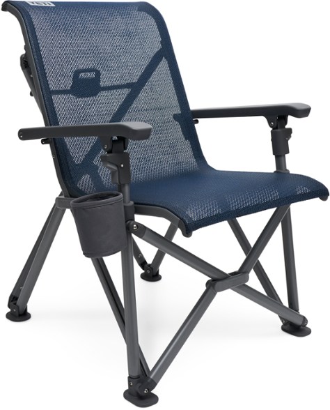 Side angle view of the YETI TrailFlex camp chair set up near a trailhead, showcasing its portable folding frame.