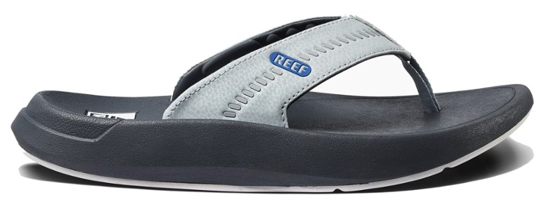 Men wearing Cruiser Comfort flip flops at the beach, showcasing style and comfort.