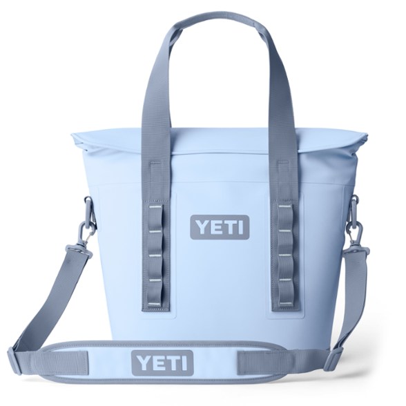 YETI Hopper M15 soft cooler in an open field, showcasing its spacious interior and magnetic lid.