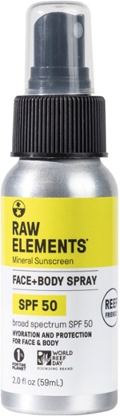 EcoCare SPF 50 mineral sunscreen spray bottle on a beach towel, showcasing its eco-friendly packaging.