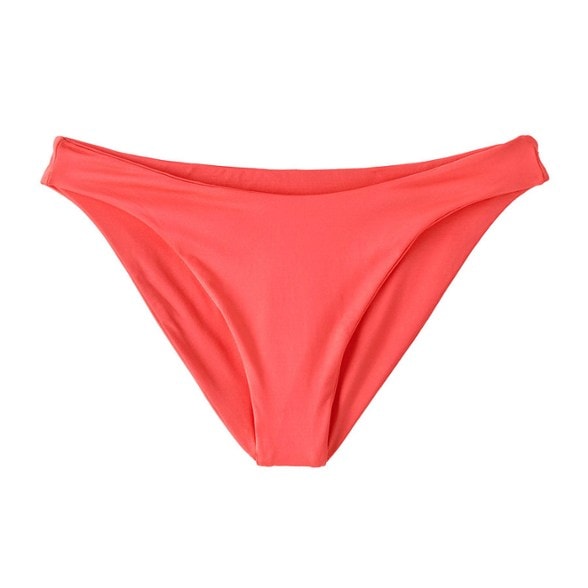 Patagonia reversible swim bottoms displayed on a beach, showcasing the mid-rise design.
