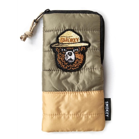 Smokey Bear outdoor gear pouch with zipper and paracord loop on a camping setup.