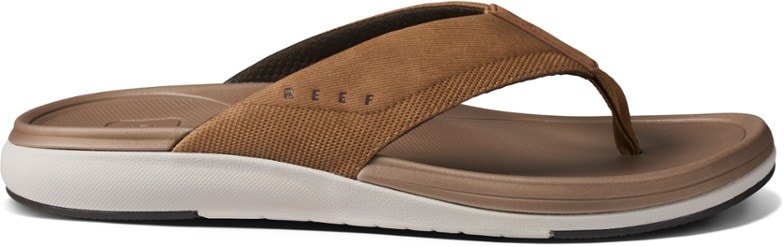 Side profile of Reef Cushion Norte flip-flops in a neutral color, showcasing the cushioned sole and strap detail.