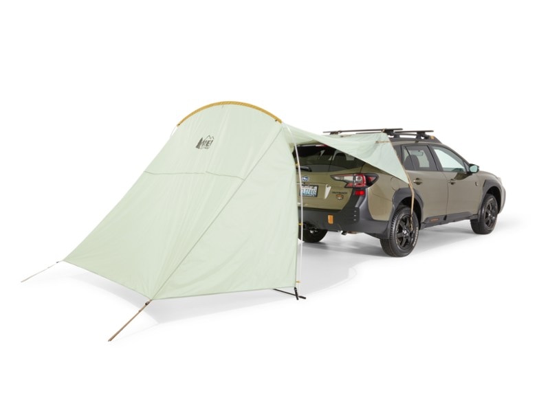 Side view of Trailgate Shelter attached to an SUV during a camping trip
