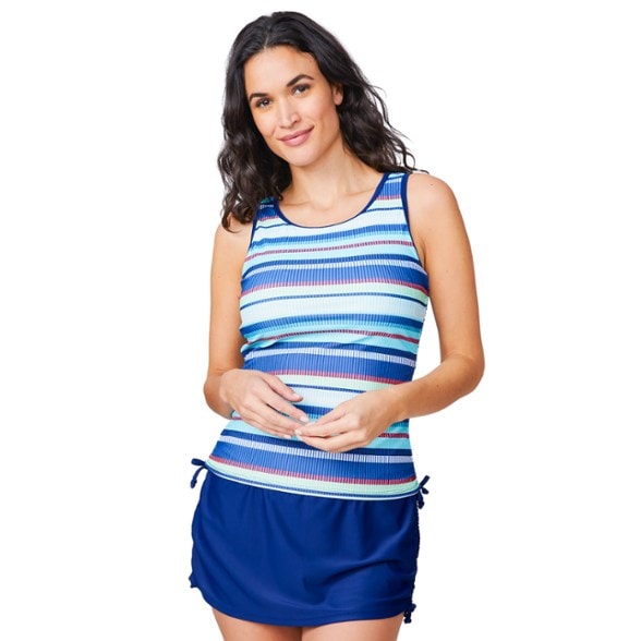 Model wearing the Horizon Dive adjustable tankini top in a vibrant blue, showcasing the side shirring and secure fit while standing by a pool.